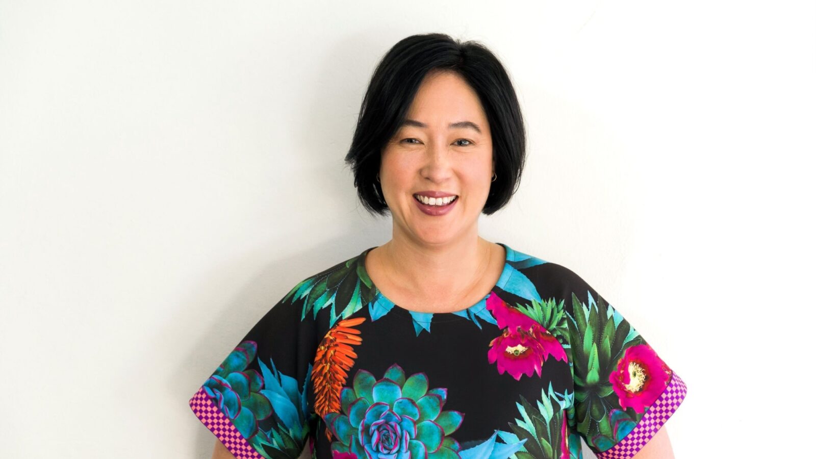 Jenny Leong in bright flowery top and smiling at the camera.