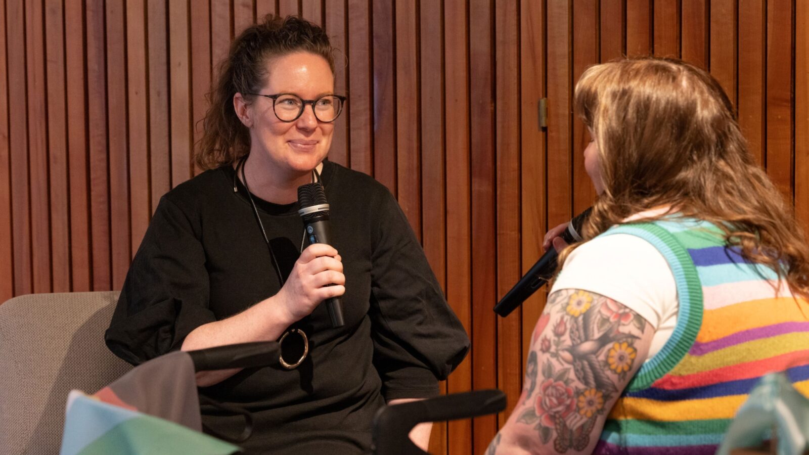 Rosie and Fiona speaking into microphones