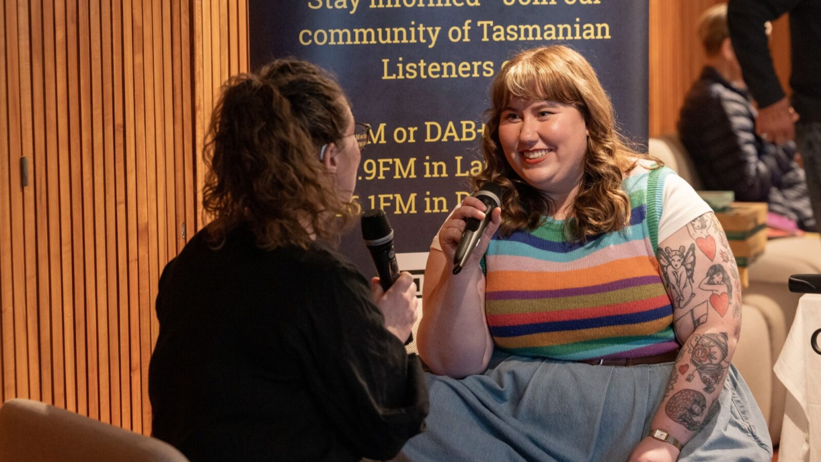 Rosie and Fiona speaking into microphones