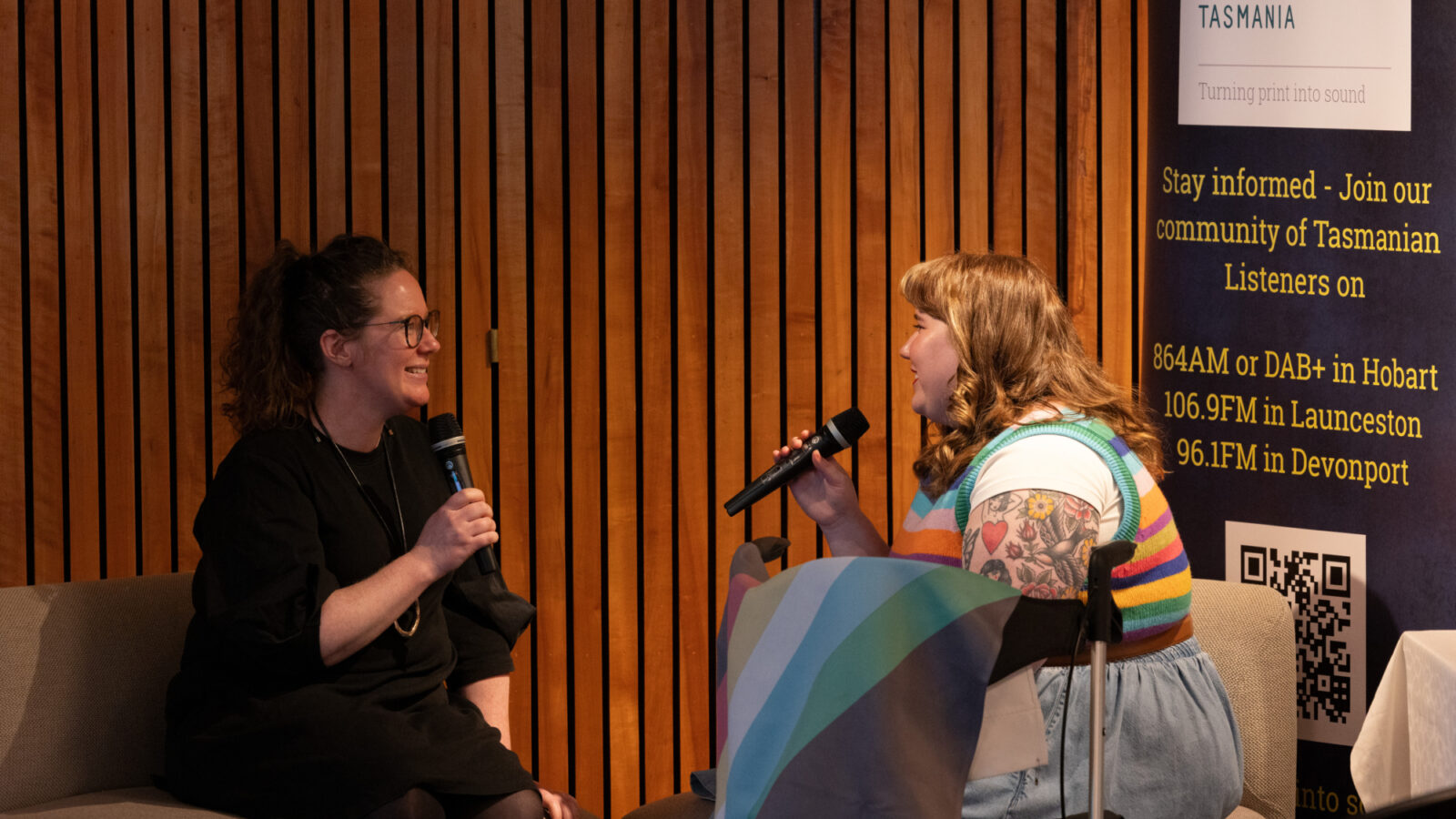 Rosie and Fiona speaking into microphones