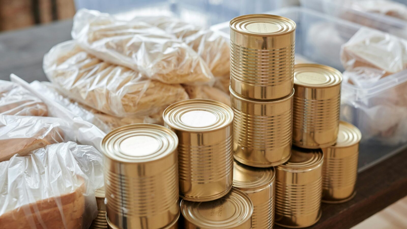 Unlabeled tins and unbranded loaves of bread on a simple table