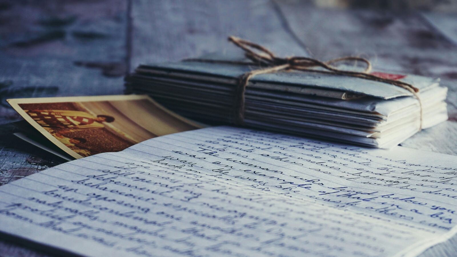 A stack of letters sitting next to one open letter
