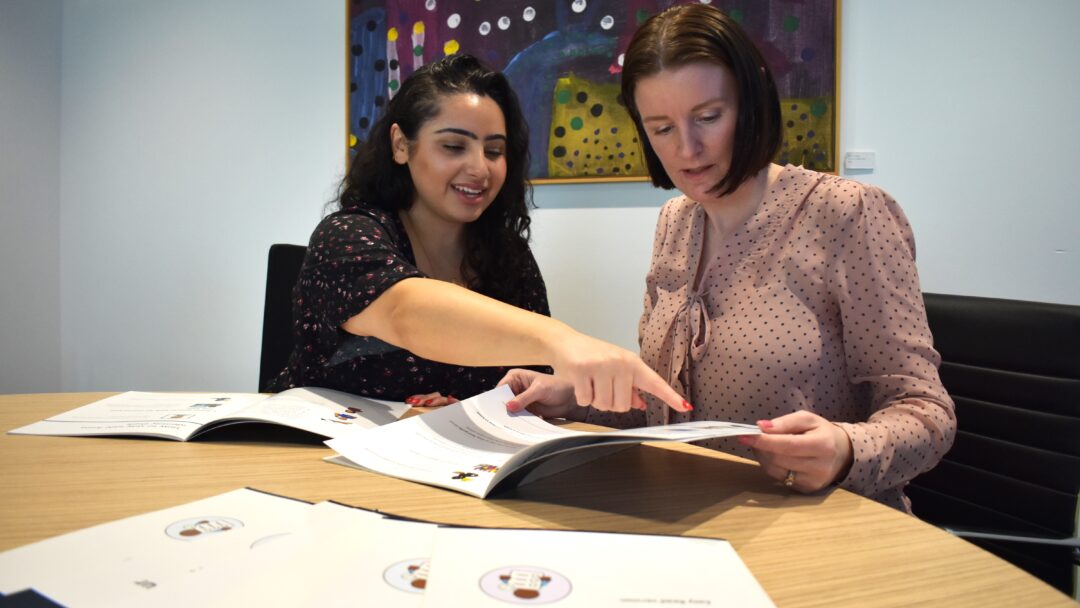 Belinda Hingston (right) discusses Scopes new Easy Read cyber security resources with Ishtar left the Communication Resource Designer who designed them.