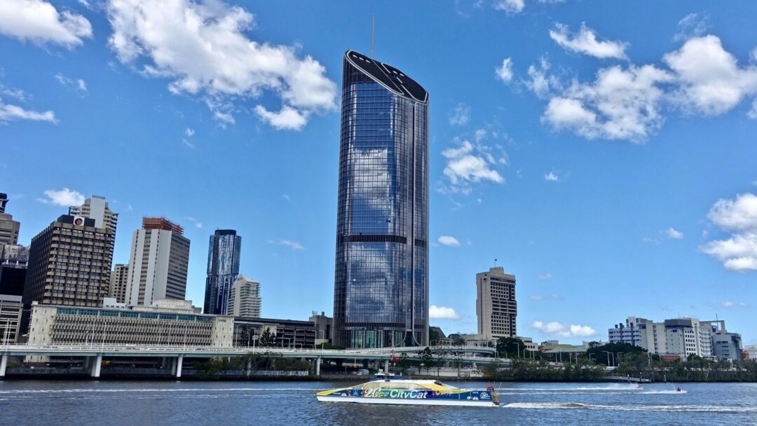 A photo of the Brisbane skyline including a ferry crossing the river