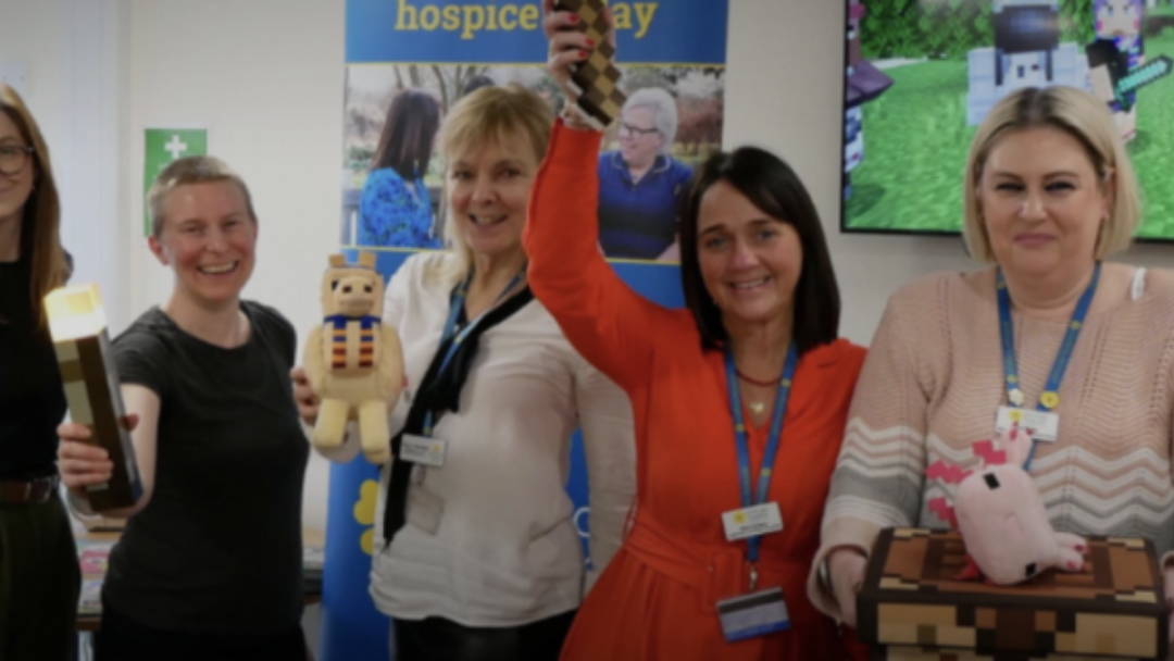 A series of seven people holding real life minecraft toys and elements