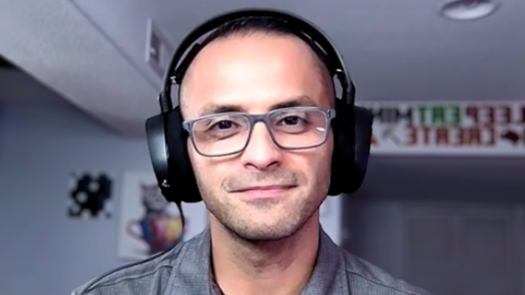 A photo of Rivera, a smiling man wearing over head headphones