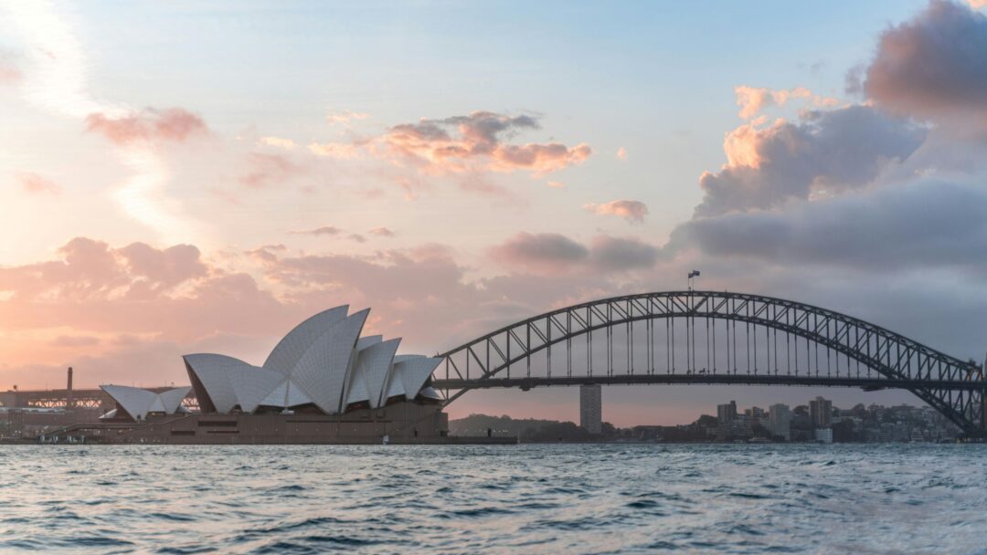 A photo of the Sydney Opera House and Harbour Bridge at sunset