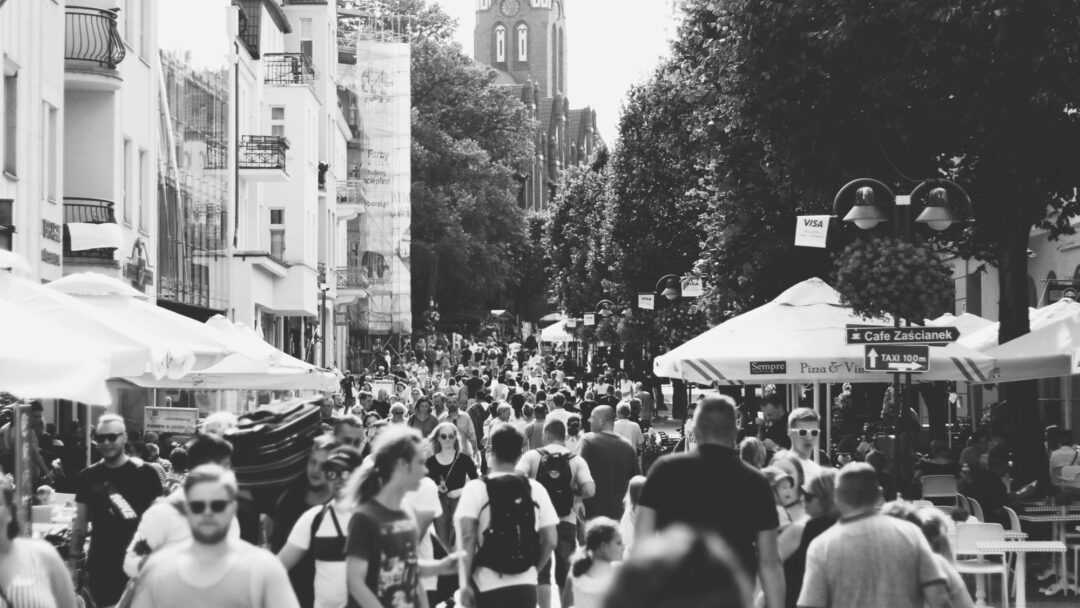 A crowd of people in an outdoor market style setting