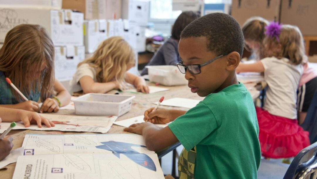 A child writing at a school desking
