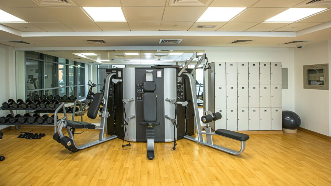 An empty gym, showing weights and lockers