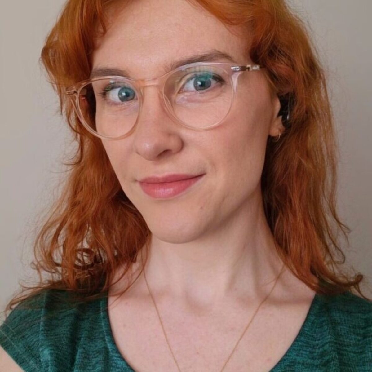 a photo of Trinity Ford in a green shirt with red hair.