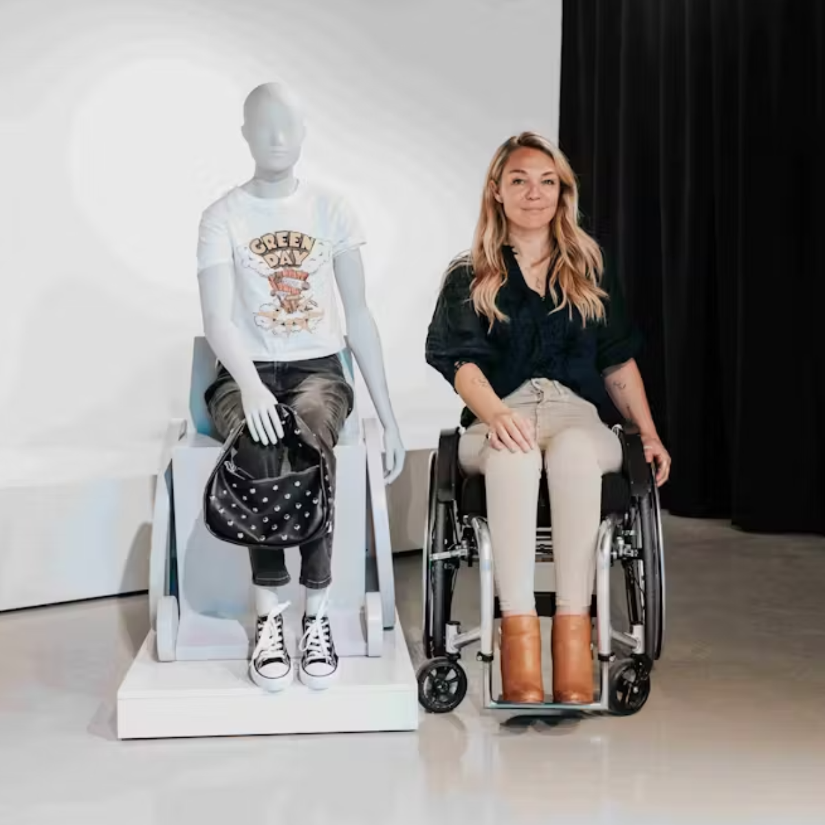 Wheelchair user Sophie Morgan sits next to the Primark wheelchair using mannequin