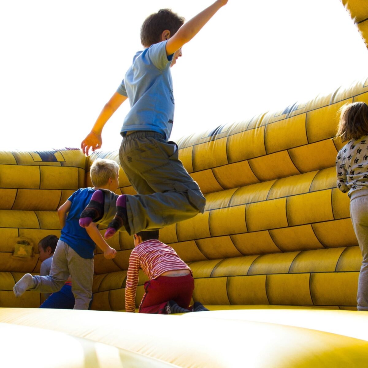 Children playing on a jumping castle.