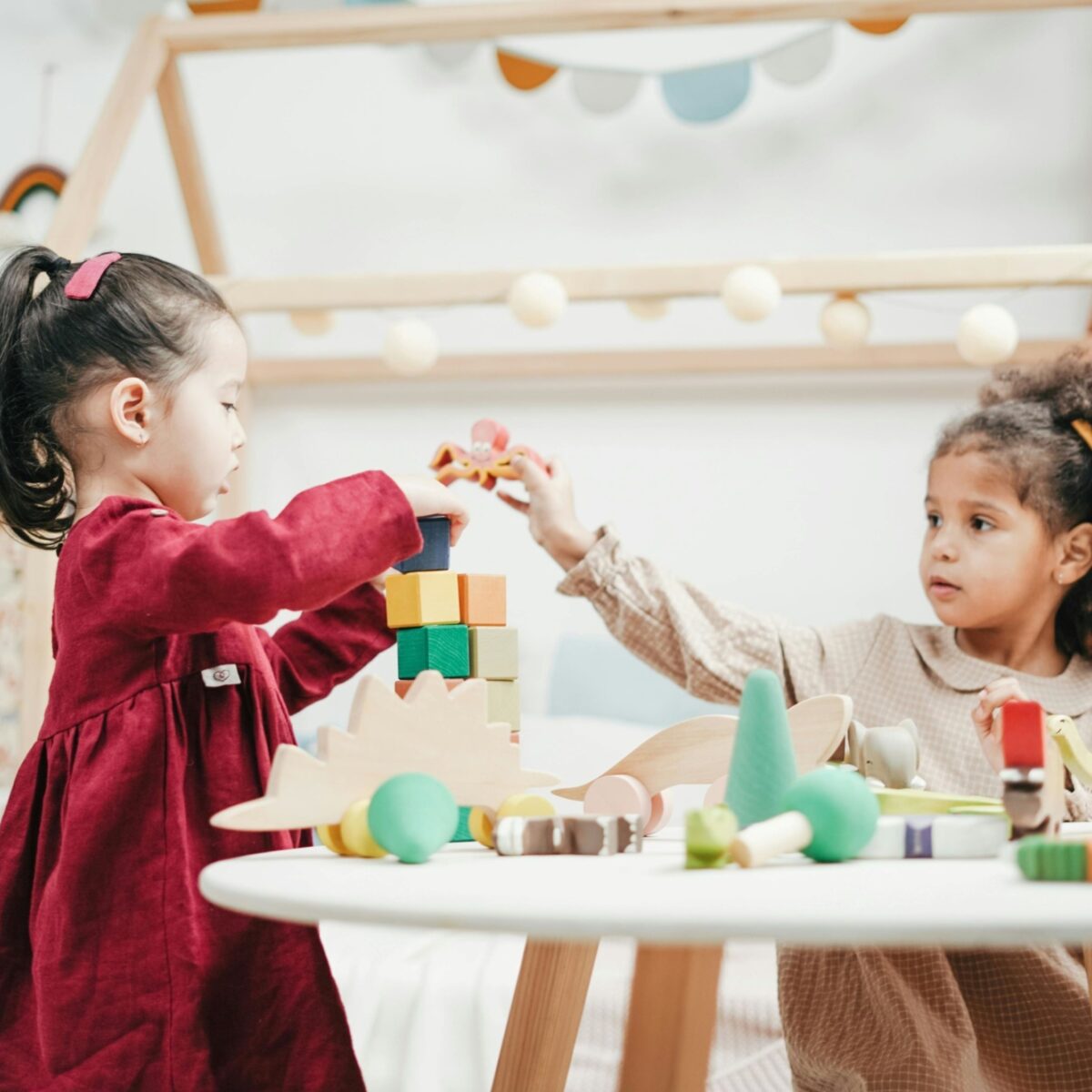 Two children playing at a small table